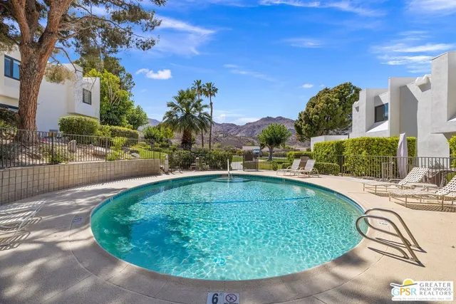 a view of a swimming pool with a lounge chairs