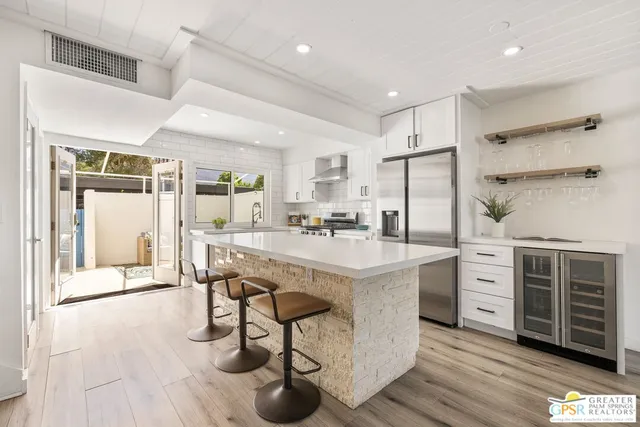 a kitchen with white cabinets and appliances