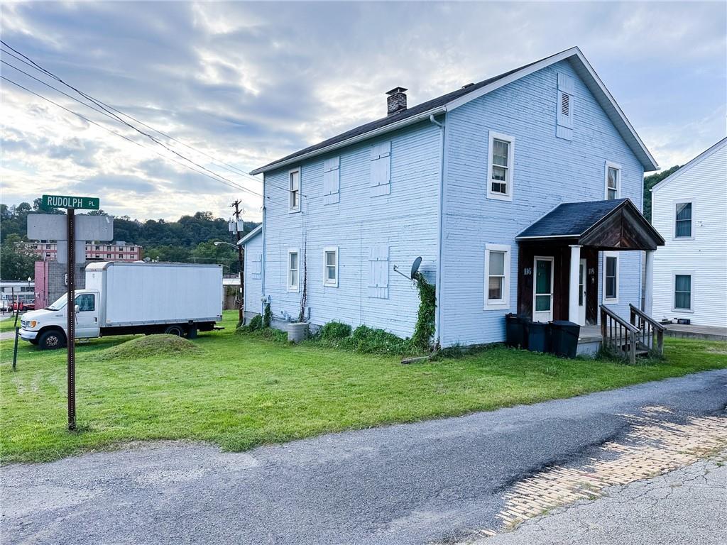 116-118 Rudolph Place Apollo, PA 15613 - Photo 2 of 12 a front view of a house with a garden