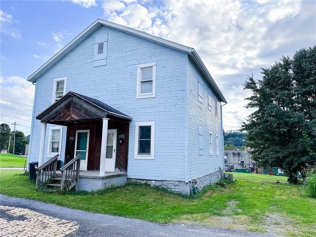 116-118 Rudolph Place Apollo, PA 15613 - Photo 3 of 12 a front view of a house with a yard and trees