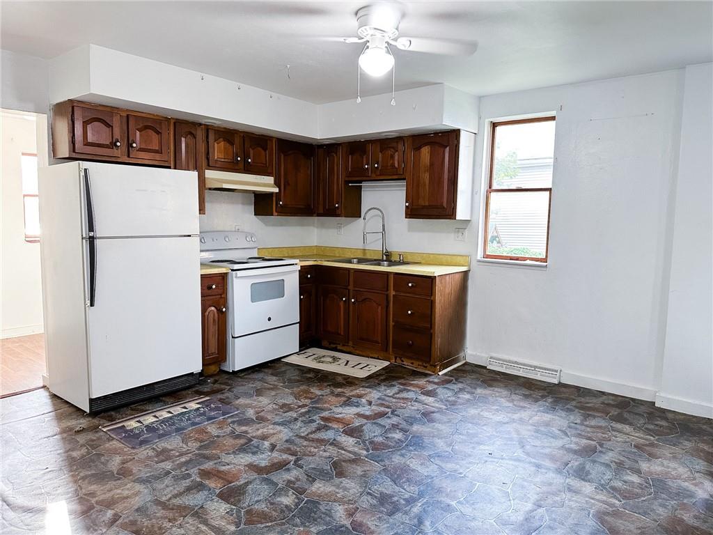 116-118 Rudolph Place Apollo, PA 15613 - Photo 7 of 12 a kitchen with stainless steel appliances granite countertop a refrigerator sink and cabinets