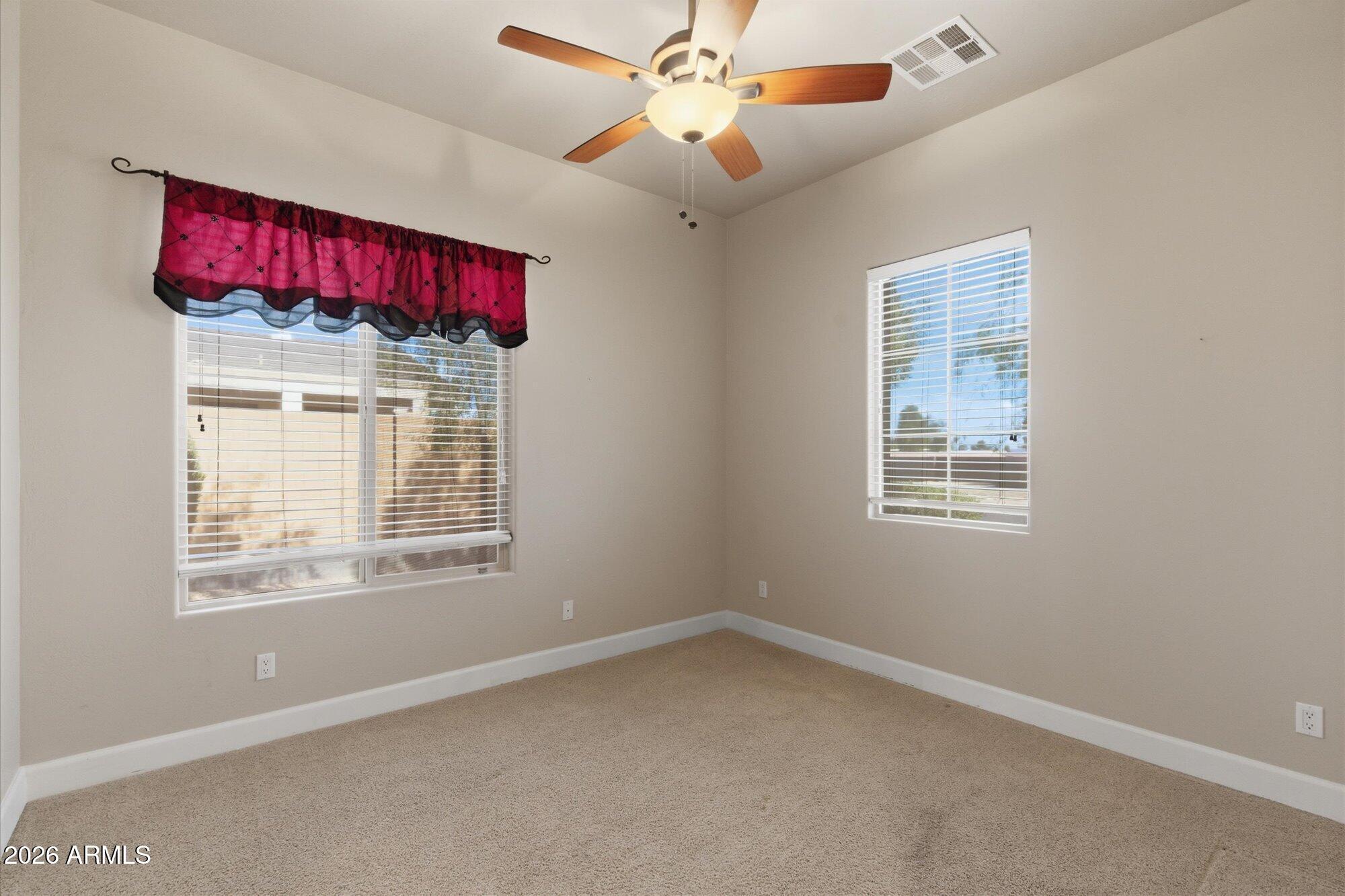 6914 West Fremont Road Laveen, AZ 85339 - Photo 22 of 32 an empty room with windows and fan