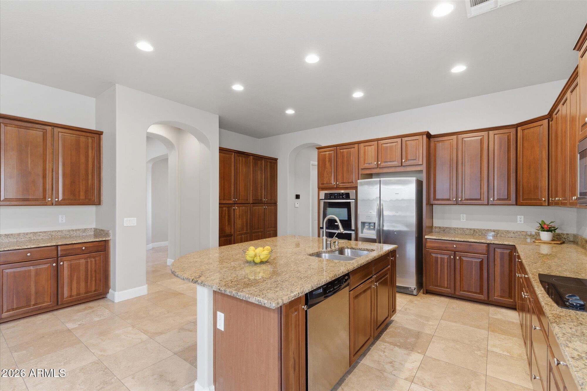 6914 West Fremont Road Laveen, AZ 85339 - Photo 5 of 32 a kitchen with stainless steel appliances granite countertop a refrigerator a sink dishwasher stove and oven