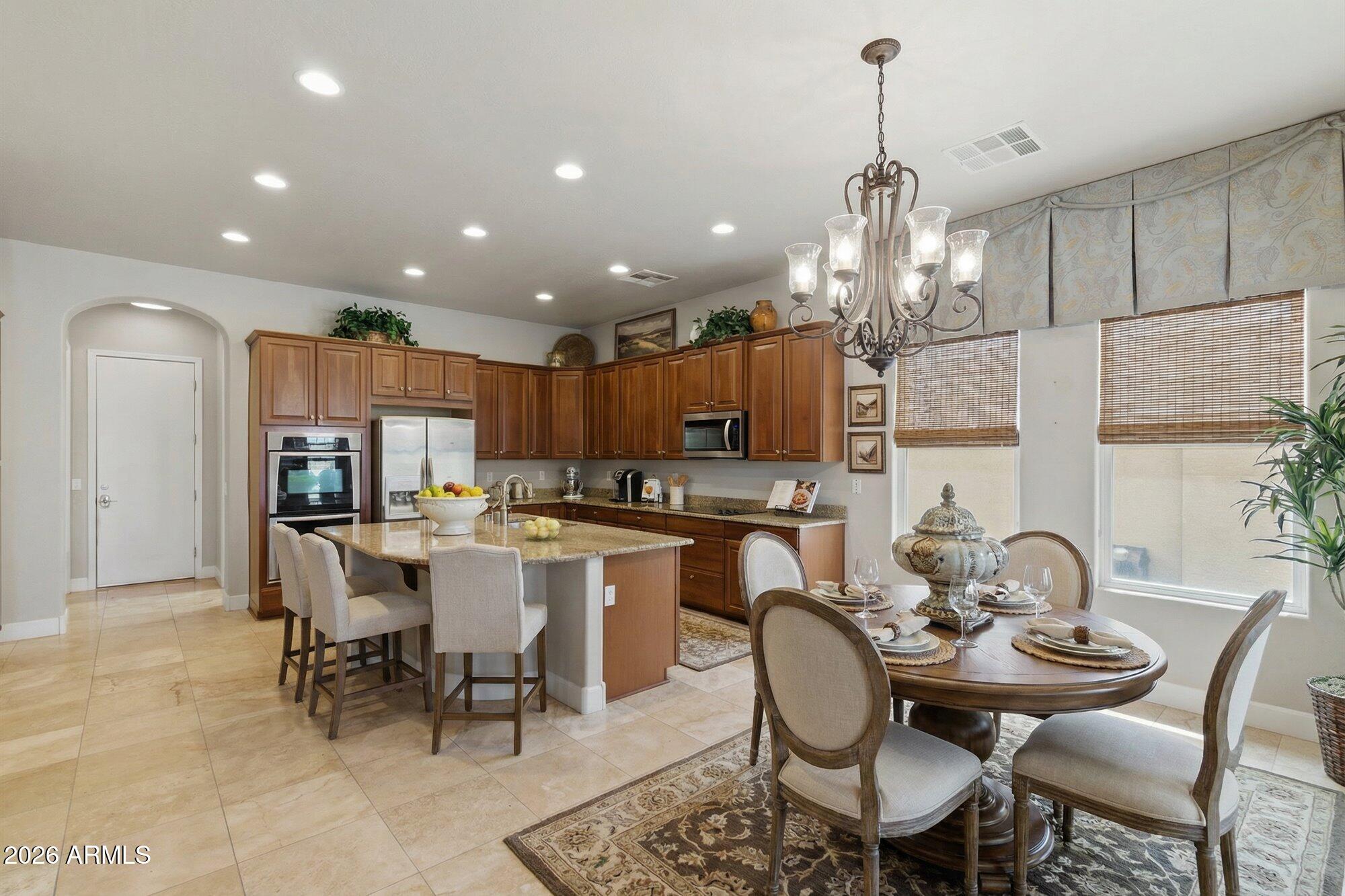 6914 West Fremont Road Laveen, AZ 85339 - Photo 7 of 32 a dining room filled chandelier and kitchen view