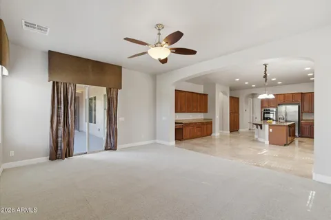 a view of a livingroom with a ceiling fan a fireplace and a ceiling fan
