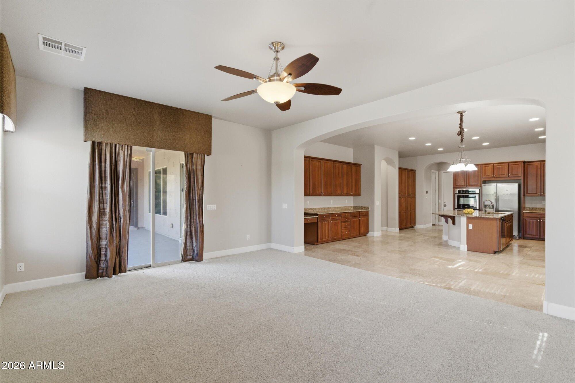 6914 West Fremont Road Laveen, AZ 85339 - Photo 8 of 32 a view of a livingroom with a ceiling fan a fireplace and a ceiling fan