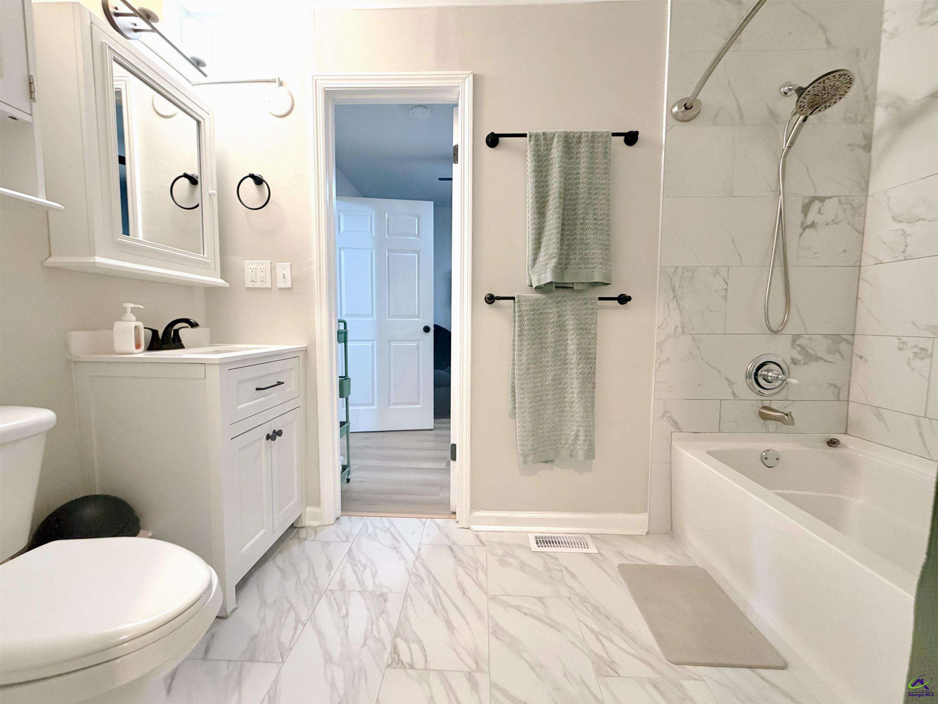 108 Weaver Road Warner Robins, GA 31093 - Photo 12 of 26 a bathroom with a sink a toilet and shower