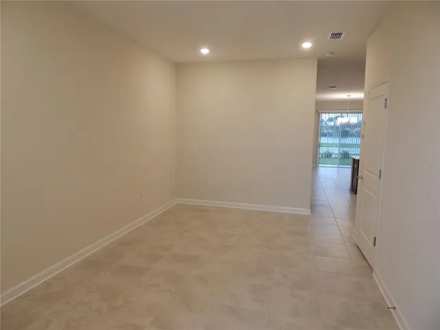 a view of empty room with floor to ceiling window
