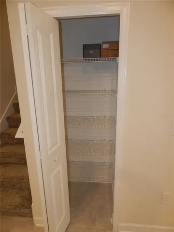 a view of staircase with white walls and windows