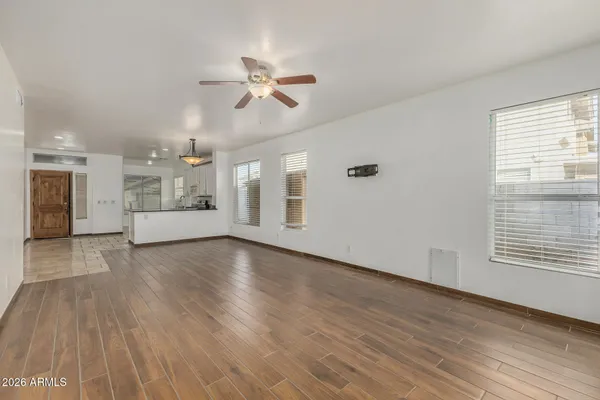 wooden floor in an empty room with a window