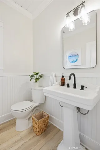 a kitchen with white cabinets and a refrigerator