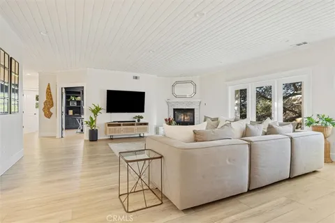 a bedroom with a bed and a flat tv screen on the dresser