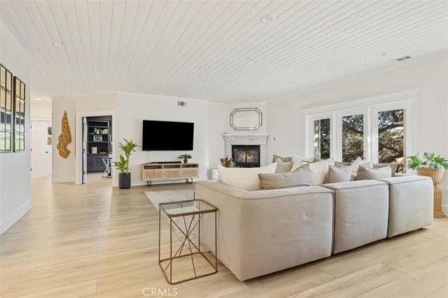 a bedroom with a bed and a flat tv screen on the dresser