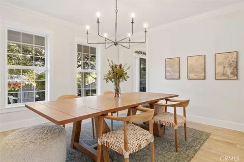 a view of a dining room with furniture and a chandelier