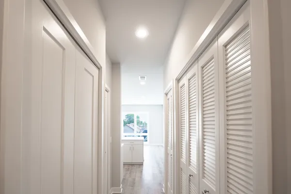 a view of a hallway with windows