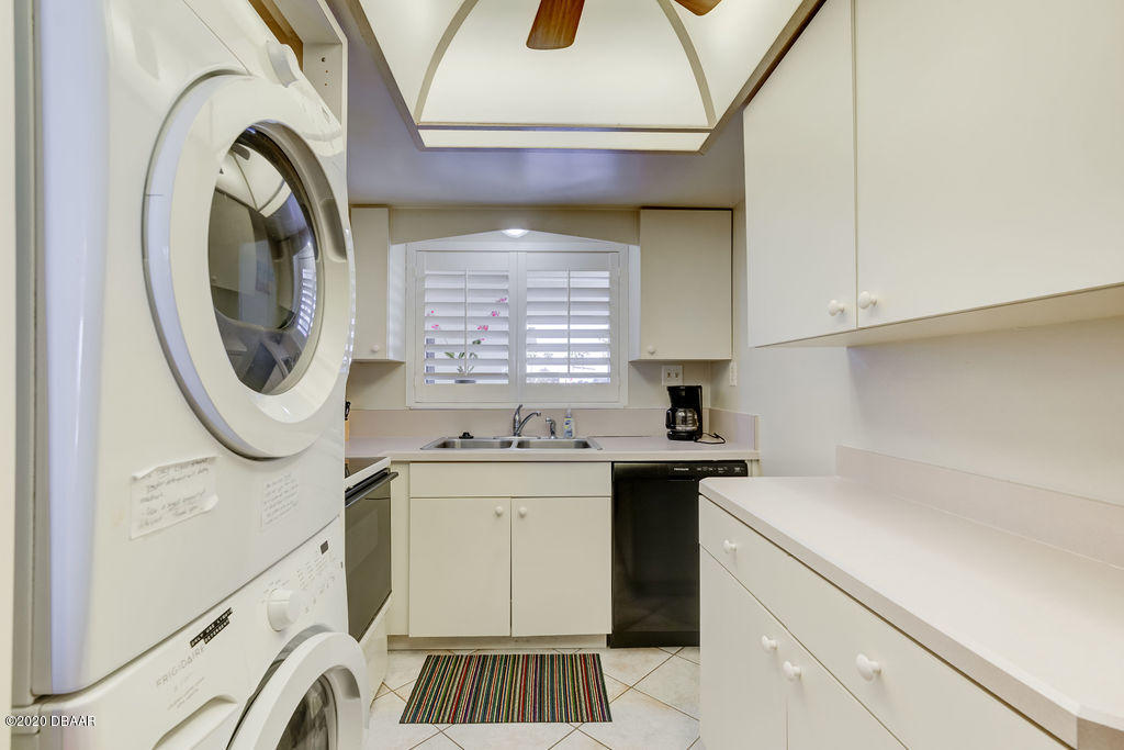 1275 Ocean Shore Boulevard, Unit 108 Ormond Beach, FL 32176 - Photo 11 of 26 a utility room with sink dryer and washer