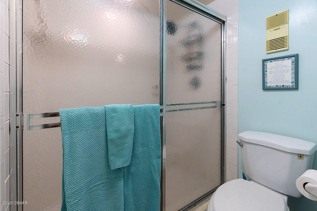 1275 Ocean Shore Boulevard, Unit 108 Ormond Beach, FL 32176 - Photo 18 of 26 a bathroom with a toilet and a shower