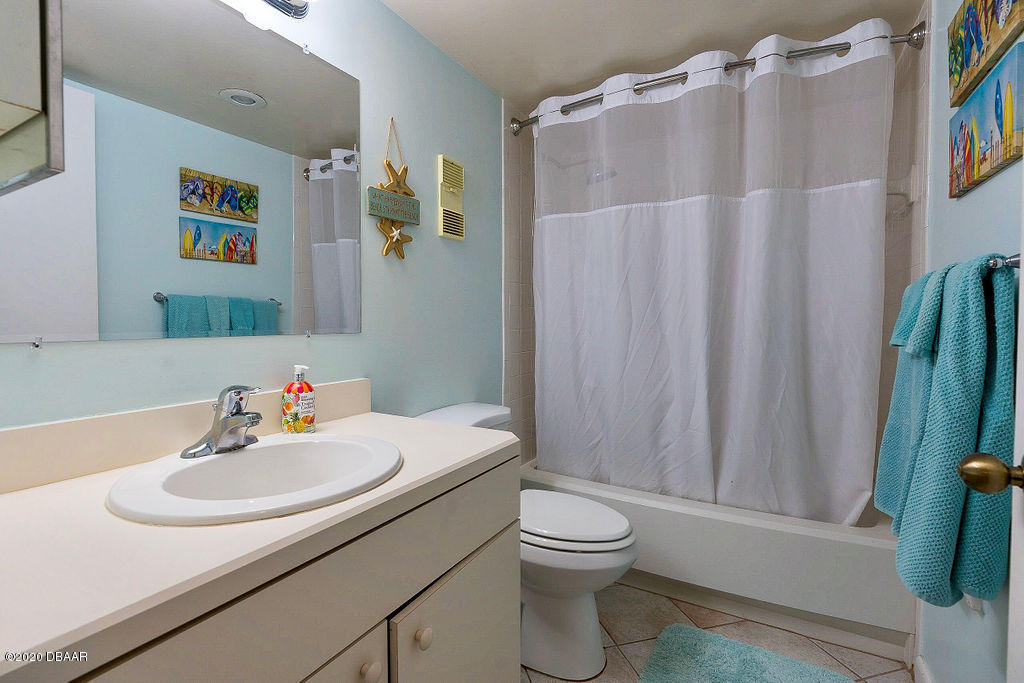 1275 Ocean Shore Boulevard, Unit 108 Ormond Beach, FL 32176 - Photo 20 of 26 a bathroom with a sink toilet and shower