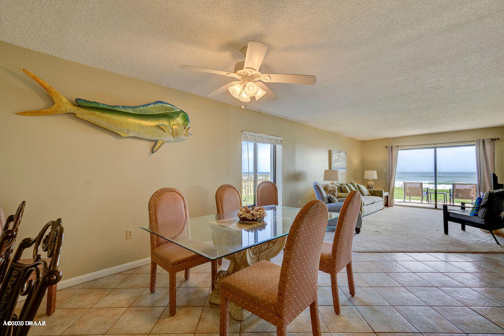 1275 Ocean Shore Boulevard, Unit 108 Ormond Beach, FL 32176 - Photo 2 of 26 a dining room with furniture and window