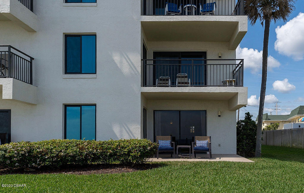 1275 Ocean Shore Boulevard, Unit 108 Ormond Beach, FL 32176 - Photo 23 of 26 a view of a house with a yard and plants