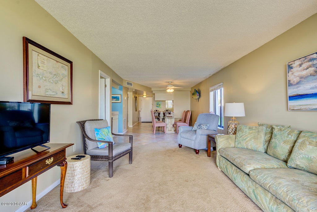 1275 Ocean Shore Boulevard, Unit 108 Ormond Beach, FL 32176 - Photo 5 of 26 a living room with furniture and a flat screen tv