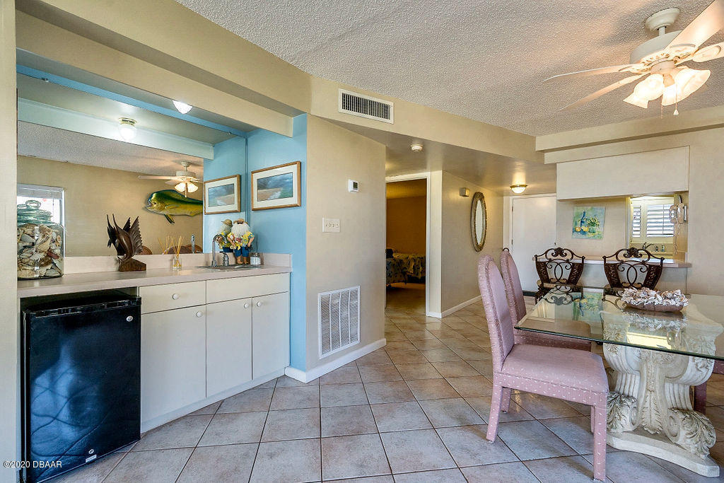 1275 Ocean Shore Boulevard, Unit 108 Ormond Beach, FL 32176 - Photo 7 of 26 a dining hall with granite countertop a table and chairs