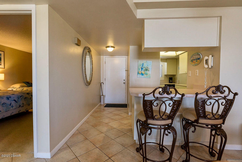 1275 Ocean Shore Boulevard, Unit 108 Ormond Beach, FL 32176 - Photo 9 of 26 a view of a livingroom with furniture and bathroom