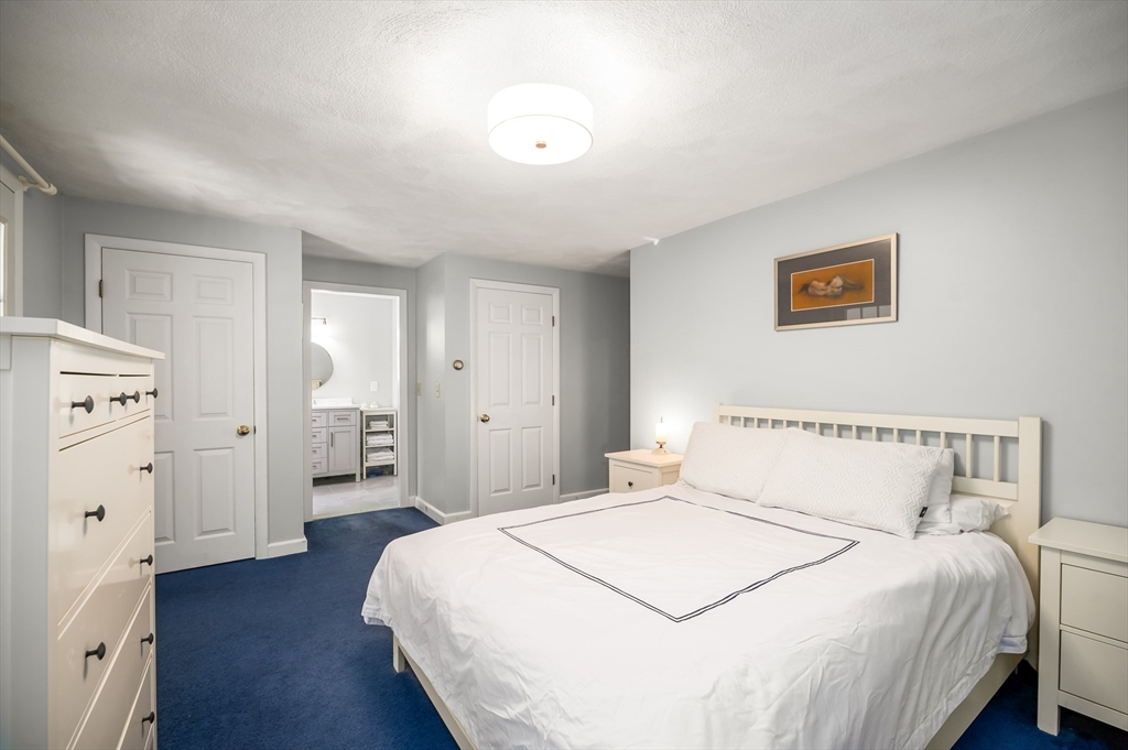 92 Pleasant Street Wenham, MA 01984 - Photo 17 of 33 a bedroom with a bed and wooden floor