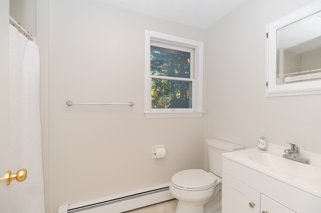 92 Pleasant Street Wenham, MA 01984 - Photo 24 of 33 a bathroom with a toilet a sink and a window