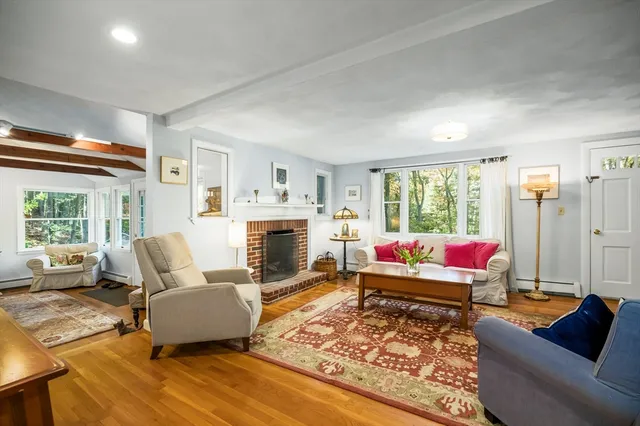a living room with furniture a rug and a fireplace