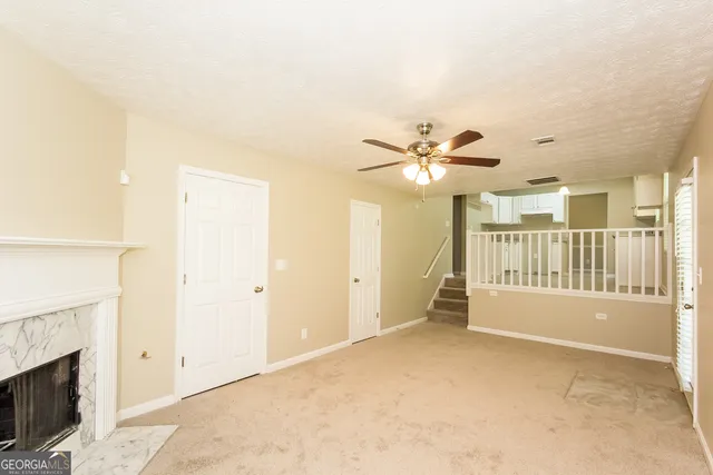 a view of an empty room with a fireplace