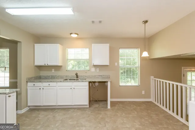 a view of a kitchen with a sink cabinets and a window