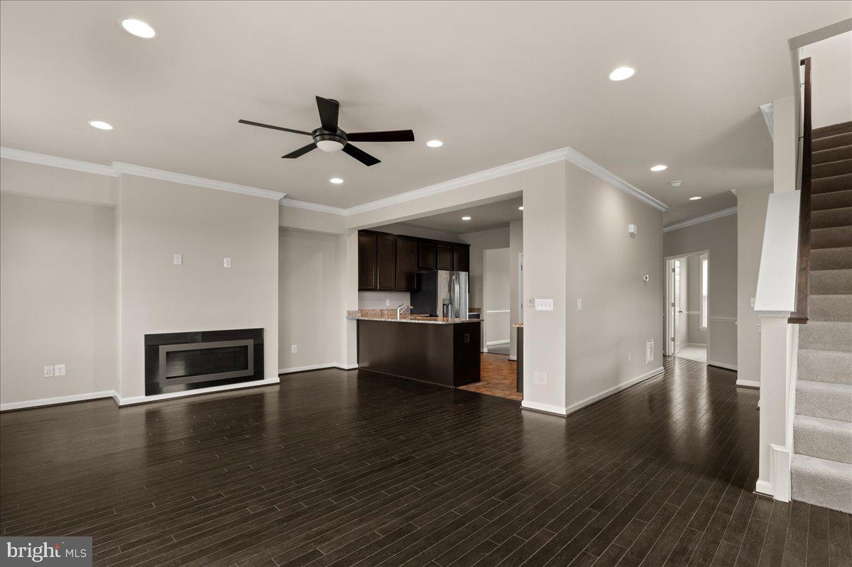 101 Jitterbug Way Stephenson, VA 22656 - Photo 6 of 39 an empty room with wooden floor fire place and kitchen view
