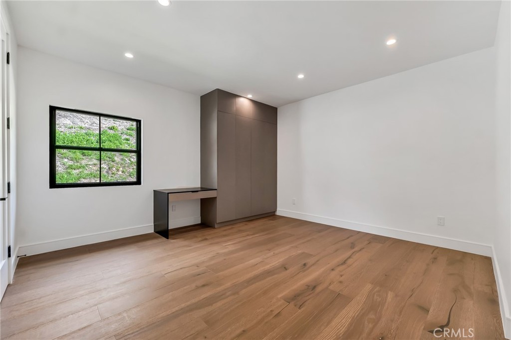 792 Gloucester Lane Thousand Oaks, CA 91362 - Photo 31 of 72 an empty room with wooden floor and windows