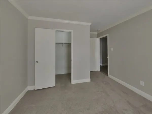 a view of an empty room and closet area