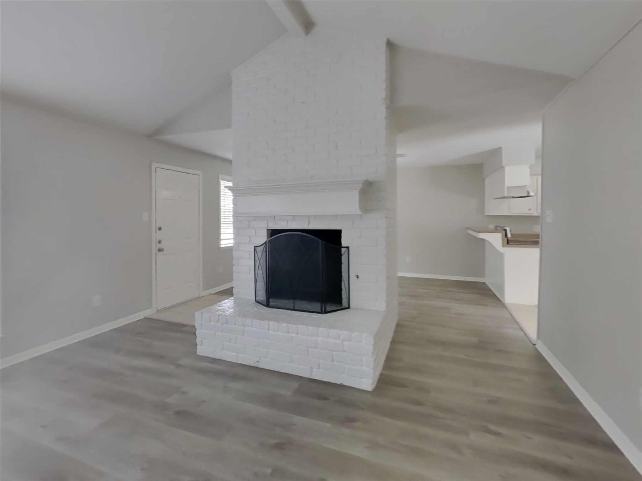 14218 Overbrook Lane Houston, TX 77077 - Photo 2 of 18 a living room with a fireplace and a wooden floor