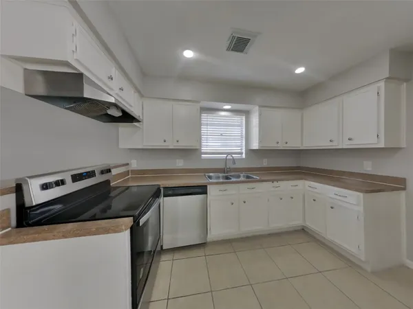 a kitchen with stainless steel appliances granite countertop a sink and a stove