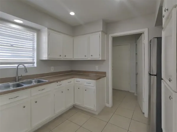 a kitchen with a sink and cabinets