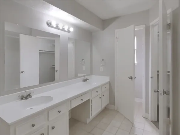 a spacious bathroom with a double vanity sink mirror and double