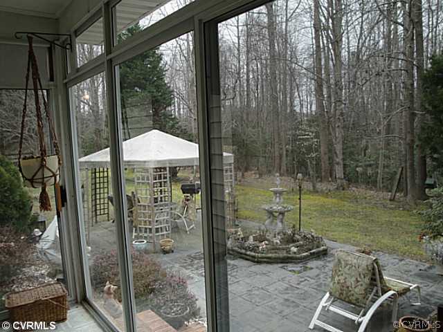 1010 Milby Town Road Shacklefords, VA 23156 - Photo 13 of 24 a backyard of a house with table and chairs