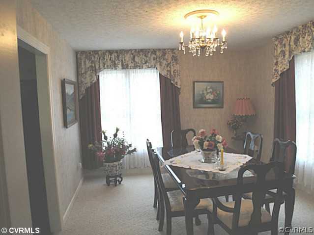 1010 Milby Town Road Shacklefords, VA 23156 - Photo 19 of 24 a dining room with furniture a chandelier and window