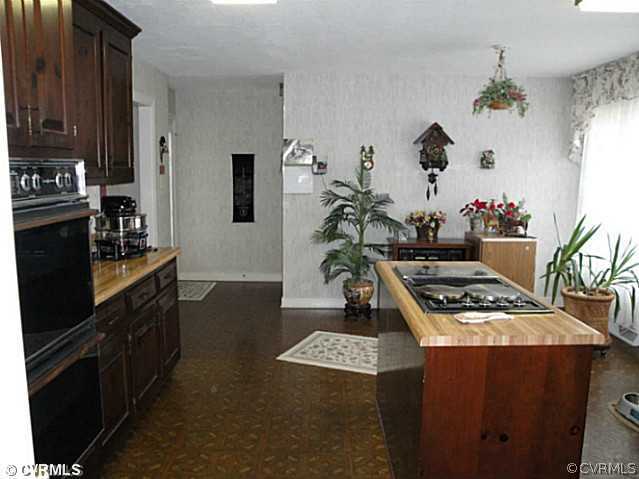 1010 Milby Town Road Shacklefords, VA 23156 - Photo 21 of 24 a kitchen with a stove and a refrigerator