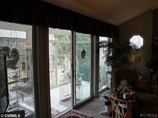 1010 Milby Town Road Shacklefords, VA 23156 - Photo 22 of 24 a view of a livingroom with furniture and floor to ceiling window