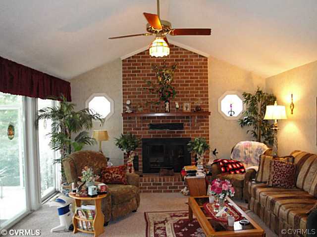 1010 Milby Town Road Shacklefords, VA 23156 - Photo 23 of 24 a living room with furniture a chandelier and a fireplace