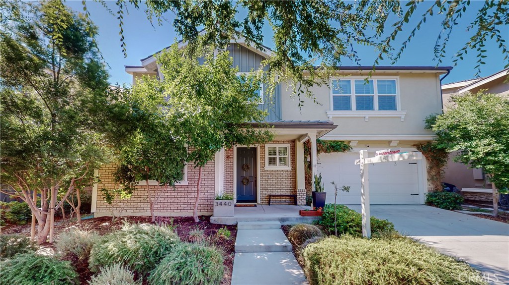3440 Pine Ridge Loop Ontario, CA 91761 - Photo 1 of 1 front view of a house with a small yard