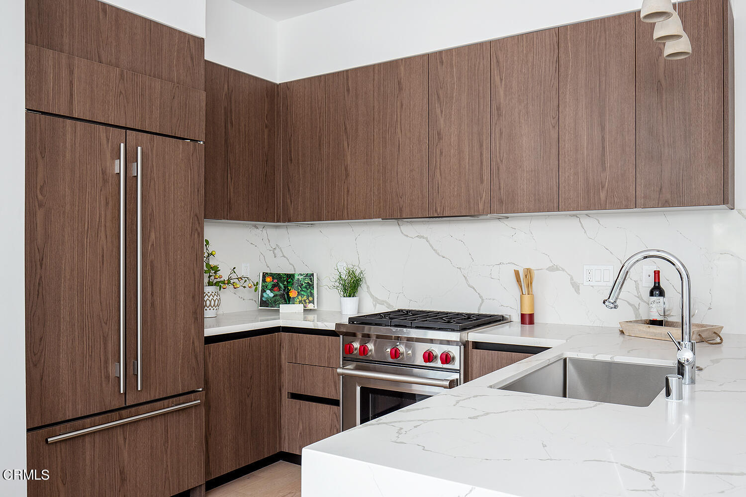 a kitchen with stainless steel appliances a refrigerator sink and cabinets