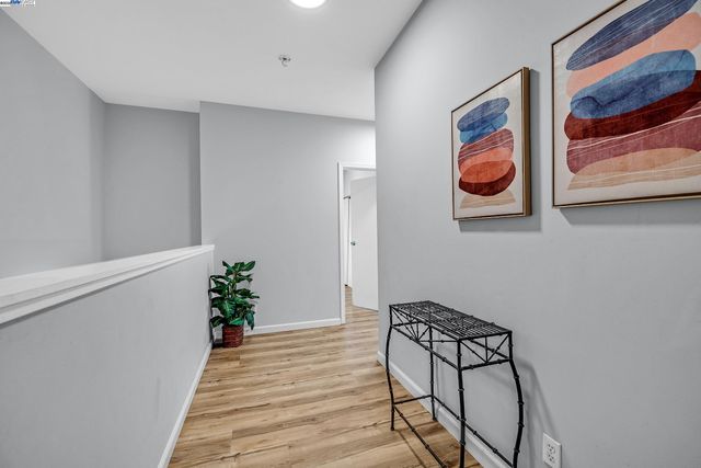 a view of a hallway with paintings on the wall