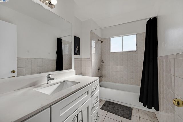 a bathroom with a sink a tub and a mirror