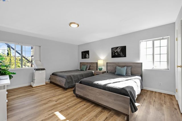 a bedroom with two beds and a potted plant