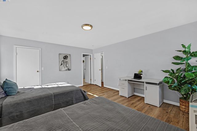 a bedroom with a bed and a potted plant